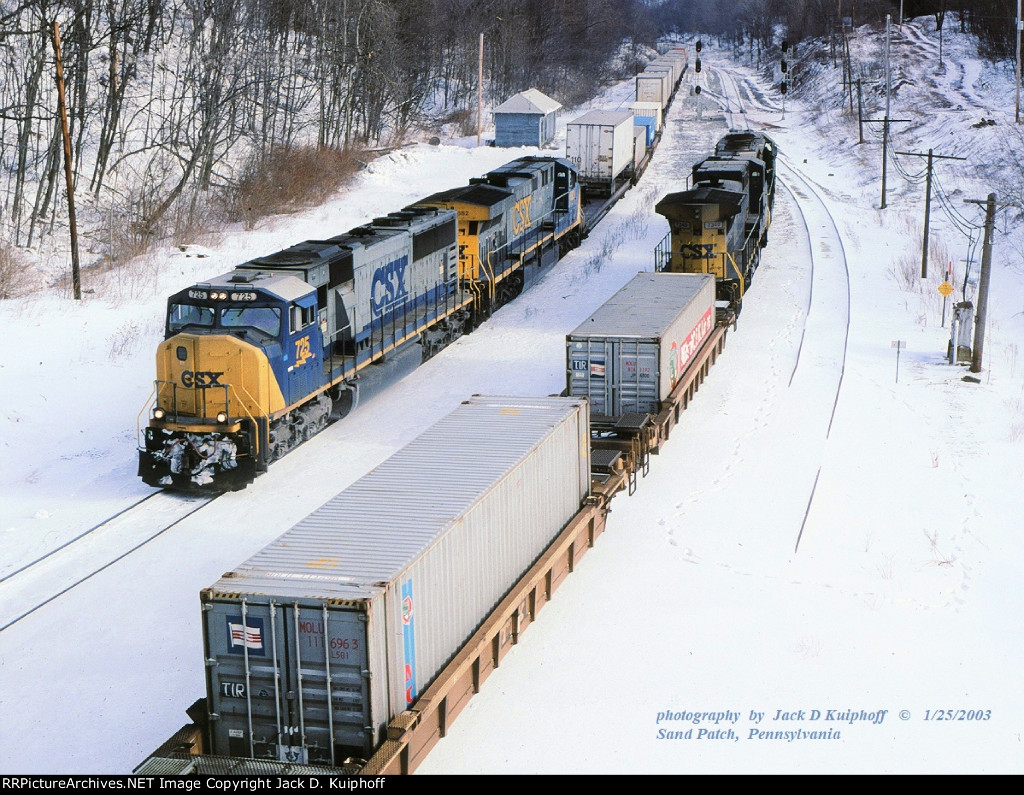 CSX SD70MAC 725, leads westbound Q137 and makes a meet with Q138 on the ex-B&O Keystone sub at, Sand Patch, Pennsylvania. January 25, 2003.